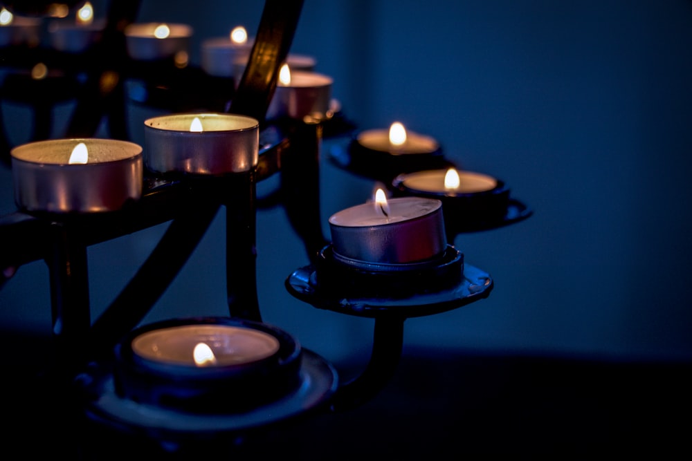 lighted candles on black metal candle holder